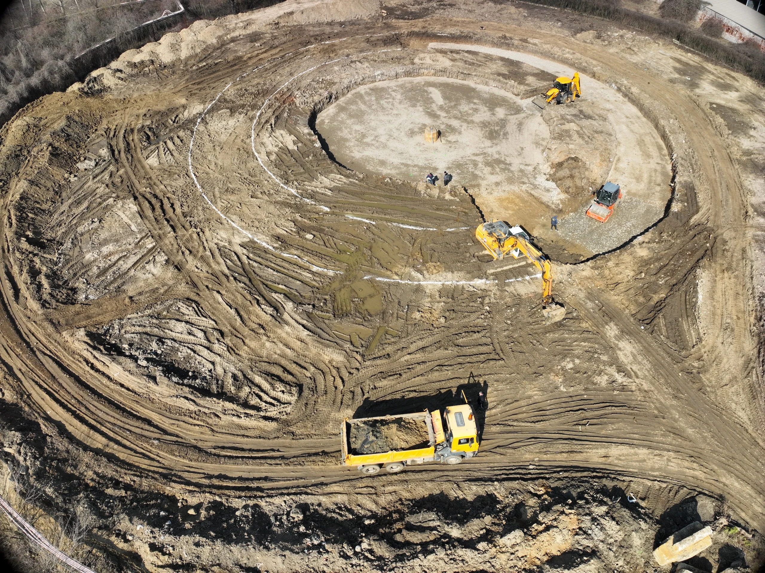 Aerial view of Building A construction site - initial excavation with construction machinery