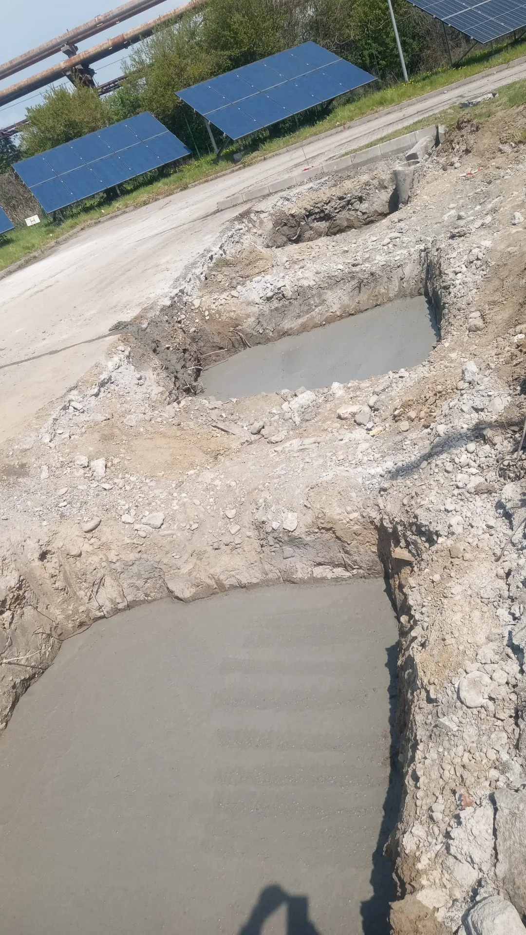 Building C foundation works - concrete pouring with solar panels in background