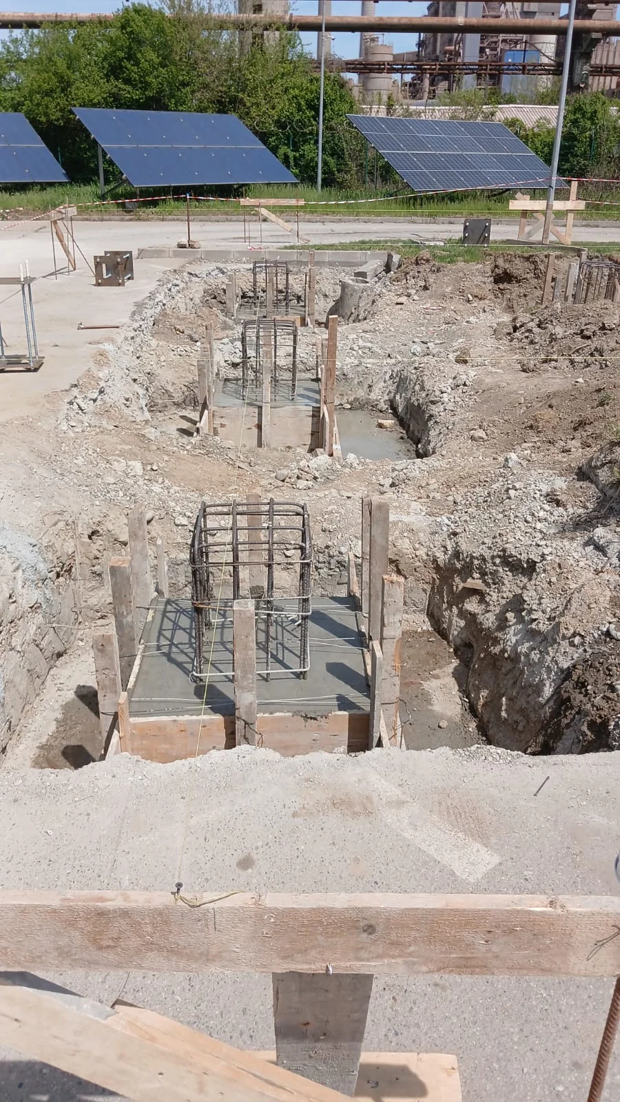 Building C foundation reinforcement cages with visible solar panels